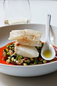 Piece of cod on a bed of diced southern vegetables