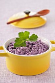 Mashed purple potatoes in a small casserole dish