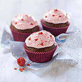 Chocolate cupcakes topped with raspberry whipped cream