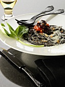 Squid ink spaghetti with purple peppers