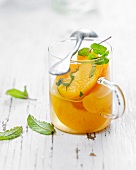 Peaches in syrup with fresh mint