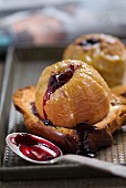 Baked apples on sliced brioche with redcurrant jam