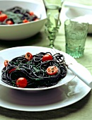 Squid ink pasta with cherry tomatoes and sage