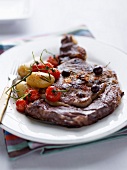 Grilled beef entrecôte with olives,cherry tomatoes and Ratte potatoes