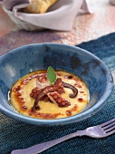 Cream of orange lentil soup with octopus