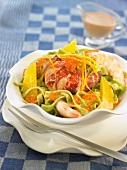 Tagliatelles salad with spinach, lobster, shrimps and orange