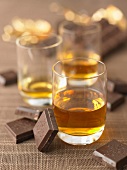 Glassses of liqueur and squares of chocolate