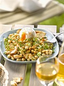 White haricot bean salad with pink garlic and a soft-boiled egg