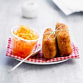 Breaded ham and mash bites with grated carrots
