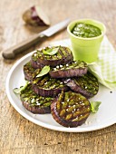 Grilled slices of eggplant with pesto