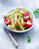 Penne with pesto and cherry tomatoes stuffed with ricotta