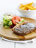 Grilled sirloin steak with mixed salad and french fries