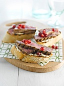 Beef,hummus and pomegranate open sandwiches