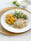 Piece of veal with lime sauce,fried potatoes and salad