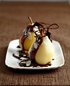 Poached pears with melted chocolate and thinly sliced almonds