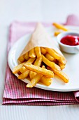 Cone of french fries with tomato ketchup