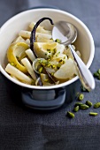White asparagus,artichoke bases and turnips with pistachios in a vanilla-flavored broth casserole