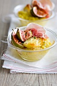 Mashed potatoes grilled with Raclette cheese, raw ham and roasted figs