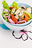 Lettuce, marinated chicken, sun-dried tomato and red onion salad