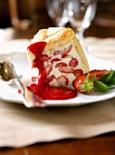 Slice of strawberry charlotte with raspberry puree