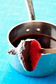 Chocolate fondue with strawberries and coconut