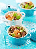 Small casserole dishes of duck and gambas