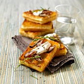 Waffles topped with smoked eel and cream