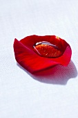 Honey in red rose petals