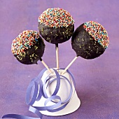 Toffee lollipops coated in chocolate and multicolored sugar