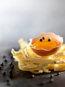 Egg yolk on a nest of tagliatelles