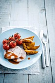 Rolled turkey with gravy,tomatoes and potatoes