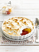 Baked peaches and raspberries with meringue topping