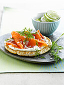 Small smoked salmon pizza and cucumber salad