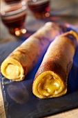 Rolled pancakes garnished with almond cream and flambeed in kirsch from Fougerolles