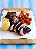 Grilled beef chop with mustard and cherry tomatoes
