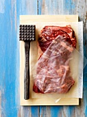 Flattening and softening the meat with a kitchen hammer