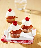 Muffin with whipped cream and cherries