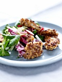 Thinly sliced chicken coated in crushed hazelnuts,radish and mixed lettuce salad