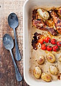 Roasted chicken drumsticks with potatoes and cherry tomatoes