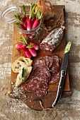 Snack with dried sausage,radishes and parsley butter