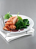 Salmon Florentine in red butter sauce, spinach with butter