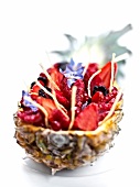 Fresh fruit served in a pinapple, mascarpone cream and strawberry juice
