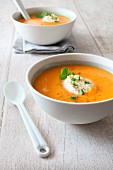 Cream of carrot and coconut milk soup with coriander and ginger