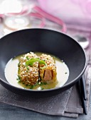 Foie gras and popcorn croquettes, creamy chicken sauce with herbs