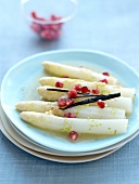 Vanilla-flavored steamed white asparagus with pomegranate seeds and lime
