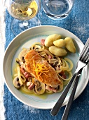 Chicken escalope marinated in orange with mushrooms, diced bacon and potatoes