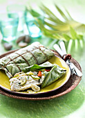 Peixe na folha de bananeira,sea bream marinated with garlic and lime cooked in a banana leaf