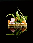 Small thin pastry vegetable tart on a black background