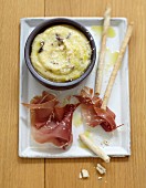 Polenta with olives,raw ham and breadsticks