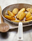 Pan-frying and caramelizing the slices of apple